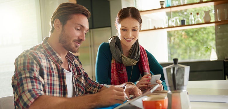 Couple discussing their finances over coffee