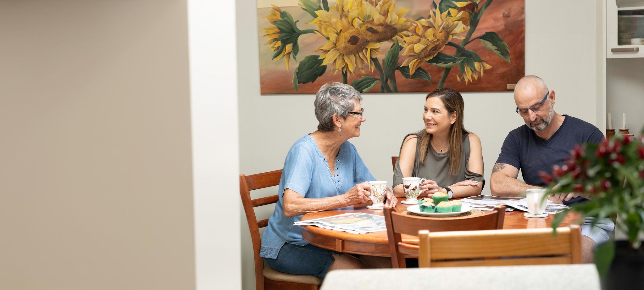 Three people talking at a table