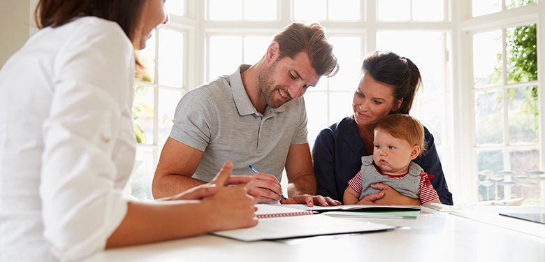 Family With Baby Meeting Financial Advisor At Home