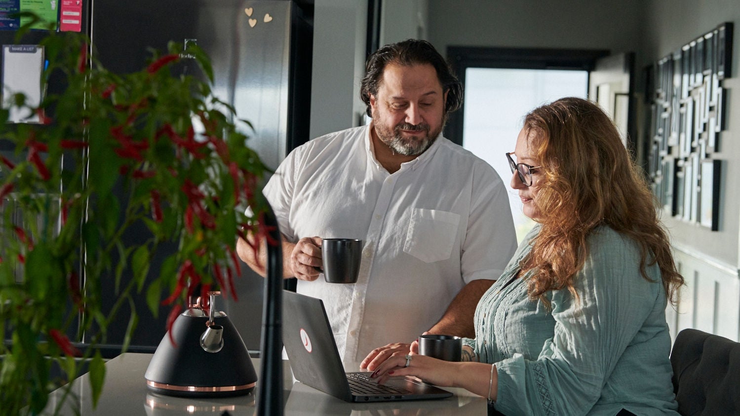 Couple using their laptop for budgeting