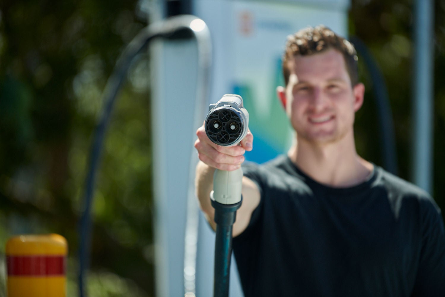 Electric car owner holding an EV charger