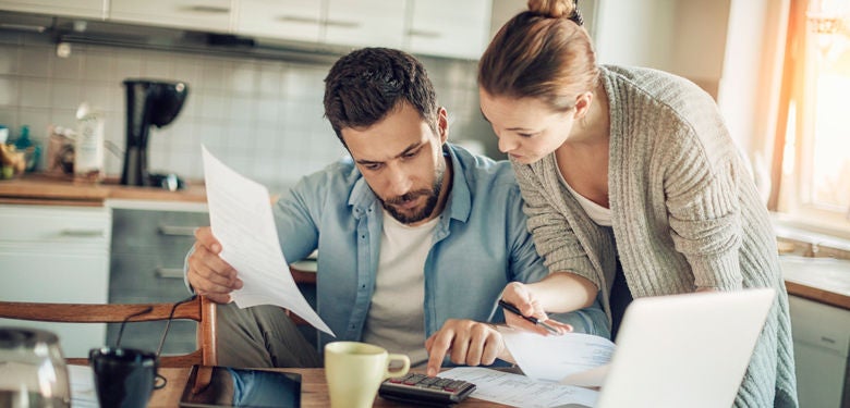 Couple looking at home loan papers and finances