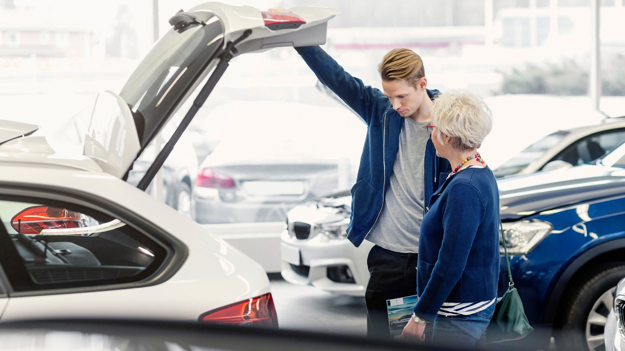 couple inspect a car