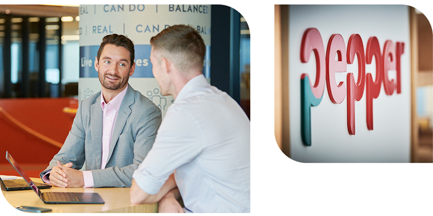 People discussing work at a table beside a laptop, with a Pepper logo sign