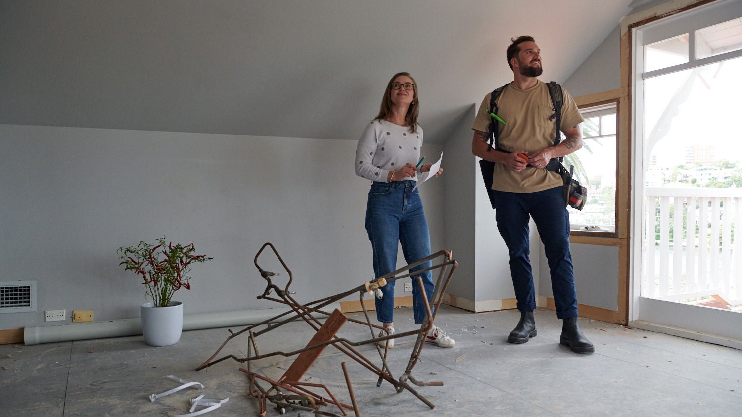 Woman briefing tradie on investment property work