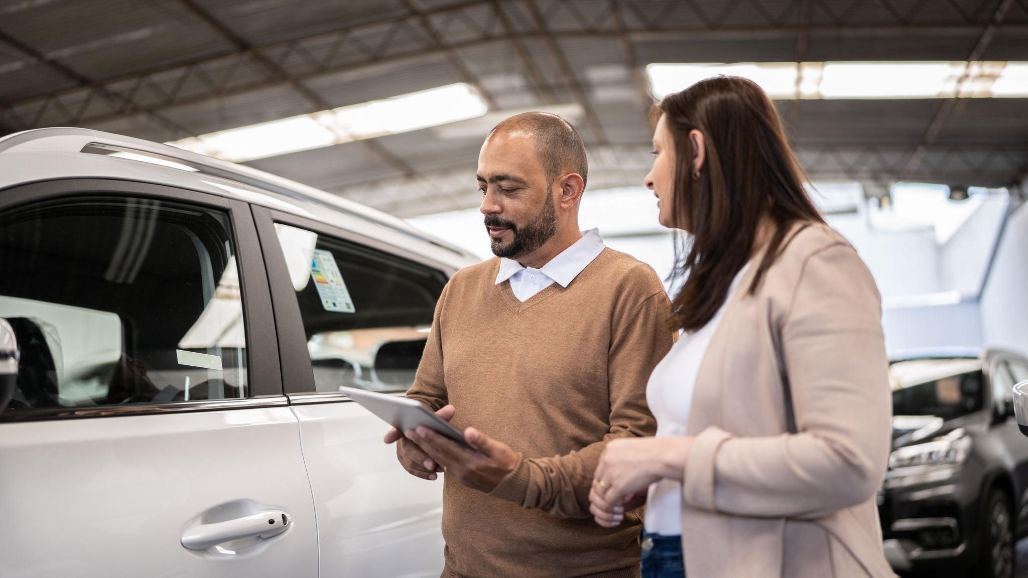 couple looking at buying a new car