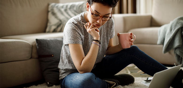 Lady managing her offset account drinking coffee